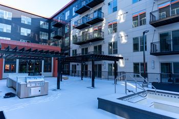 A rooftop patio with a hot tub and a slide.